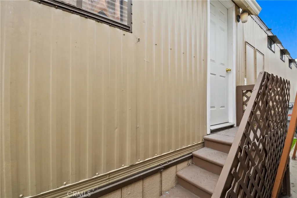 23701 South Western Avenue, Unit 197 Torrance, CA 90501 - Photo 5 of 32 a view of a room with stairs and a wooden door