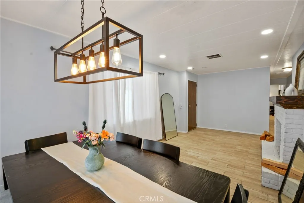 23701 South Western Avenue, Unit 197 Torrance, CA 90501 - Photo 9 of 32 a view of a dining room with furniture and a chandelier