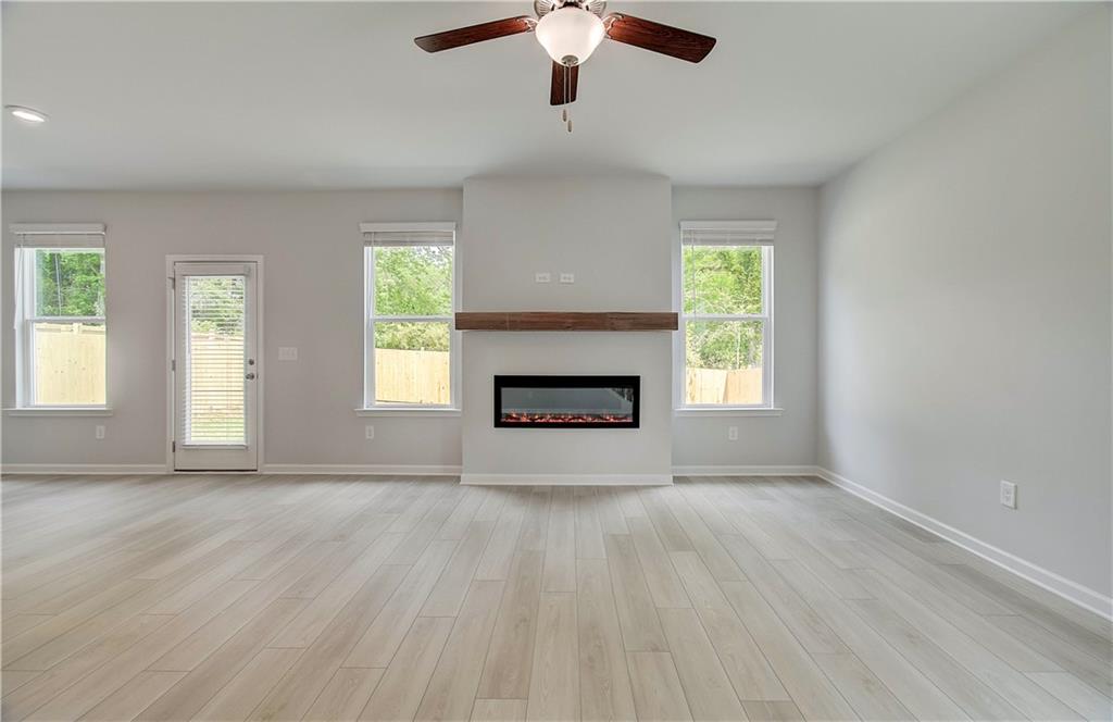 117 Alpine Road Fairburn, GA 30213 - Photo 8 of 29 an empty room with windows and fireplace