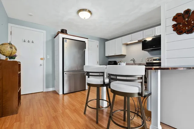 a kitchen with stainless steel appliances a refrigerator and a stove top oven