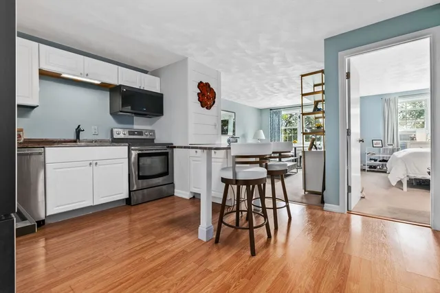 a view of kitchen with cabinets and wooden floor