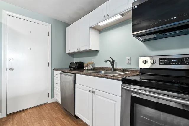 a kitchen with stainless steel appliances granite countertop a stove and a microwave