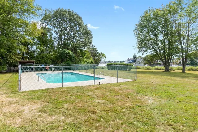 a view of a swimming pool with a yard