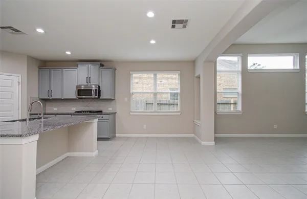 a view of an empty room with a fireplace and a window