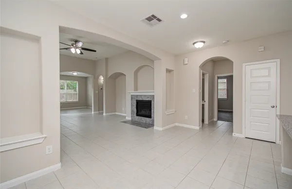 a large kitchen with stainless steel appliances granite countertop a refrigerator and a stove top oven