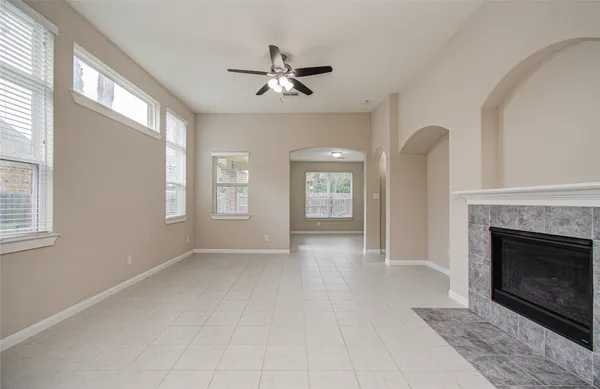 a view of a hallway with a fireplace and window