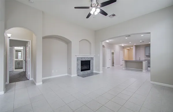 a view of a kitchen with furniture and a ceiling fan