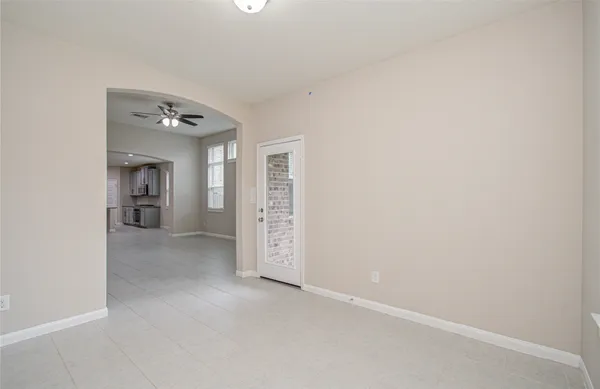 an empty room with windows and cabinet