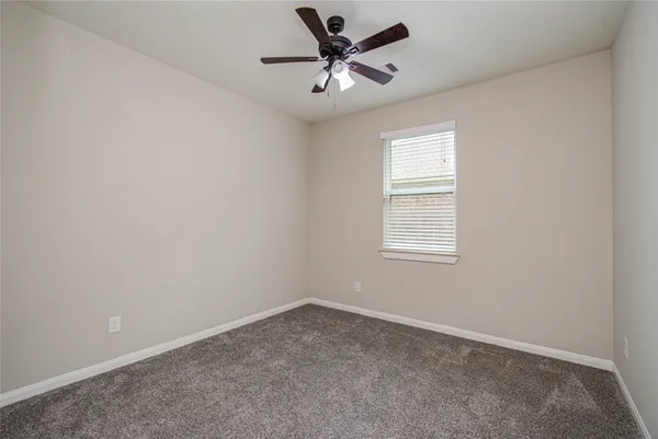 an empty room with closet and windows