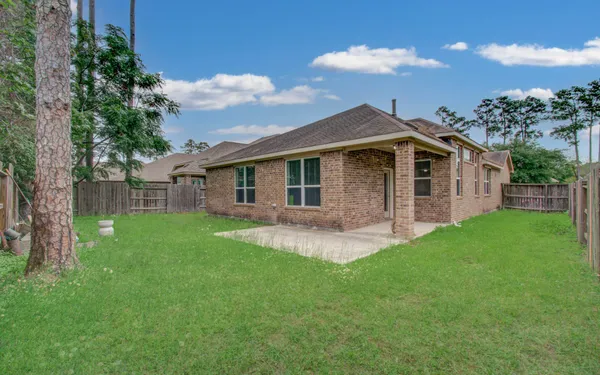 a view of a house with a yard and sitting area