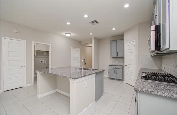 a kitchen with stainless steel appliances granite countertop a sink and cabinets