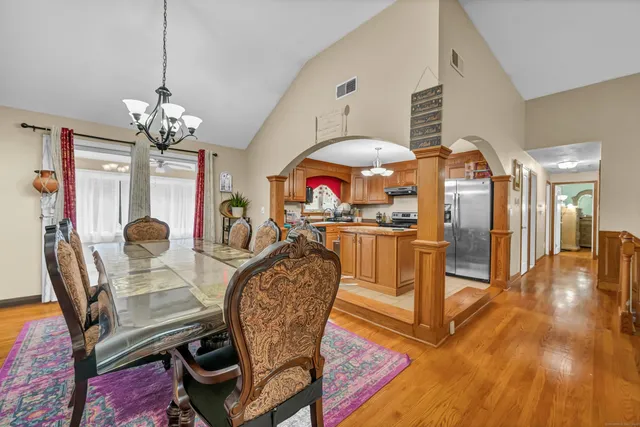 a view of a dining room with furniture and chandelier