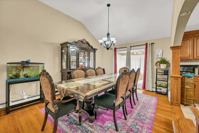 a view of a dining room with furniture and wooden floor