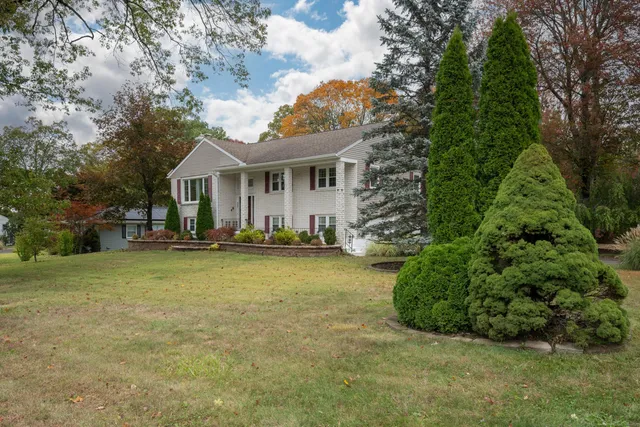 a view of a house with backyard and sitting area