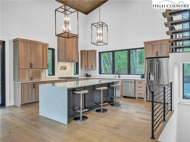a kitchen with appliances cabinets and a counter top space