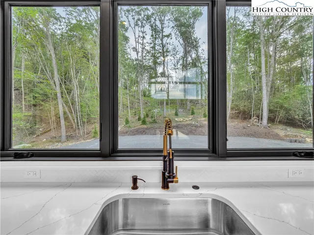 a bathroom with sink and a large window