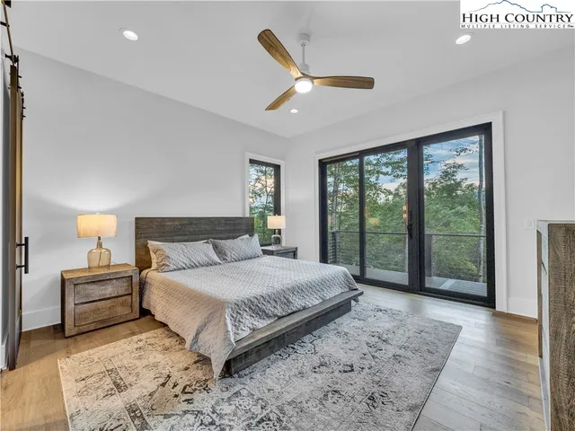 a spacious bedroom with a large bed and a large window