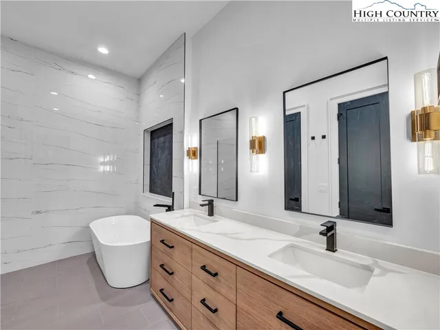 a bathroom with a double vanity sink and a mirror