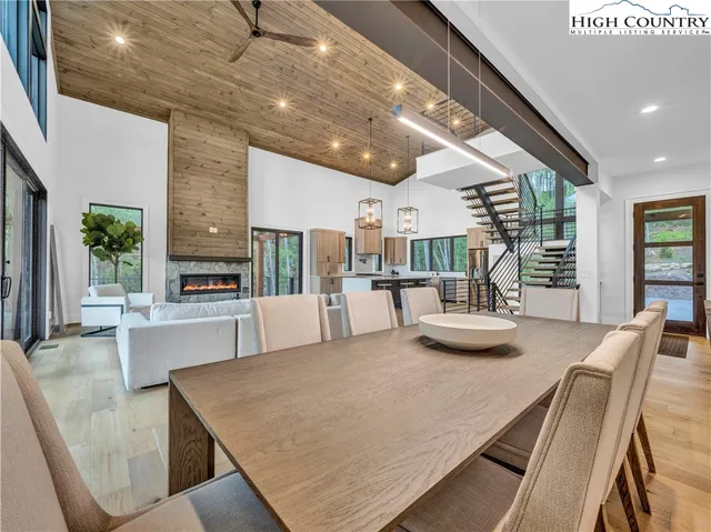 a dining room with furniture and a large window