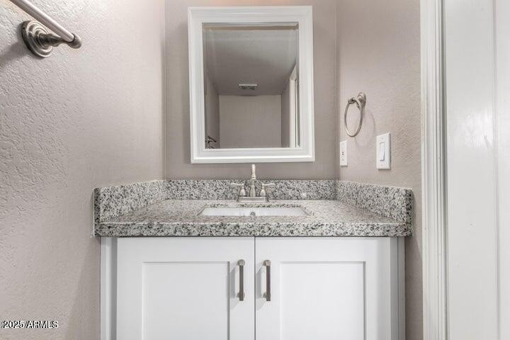 3030 North Hayden Road, Unit 16 Scottsdale, AZ 85251 - Photo 7 of 30 a bathroom with a granite countertop sink and a mirror