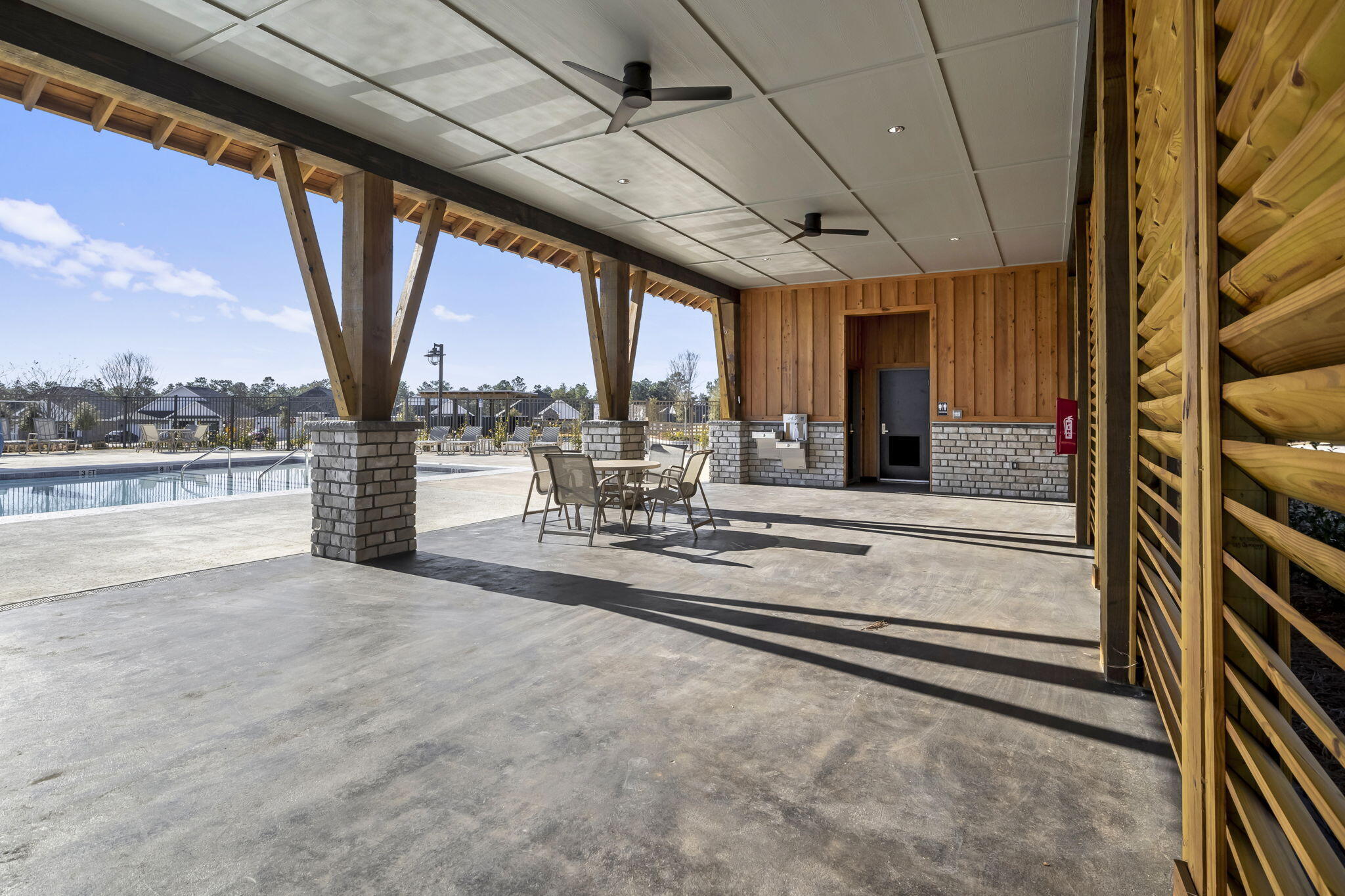 8130 Fir Tree Drive Milton, FL 32583 - Photo 22 of 37 a view of a patio with a table chairs and a patio