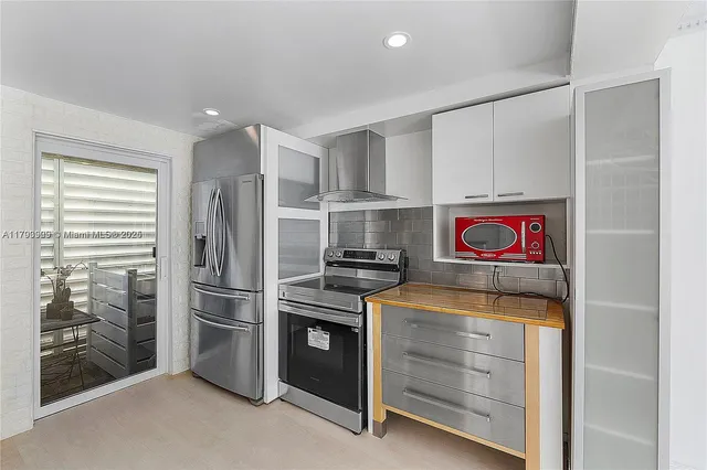 a kitchen with stainless steel appliances granite countertop a refrigerator and a stove