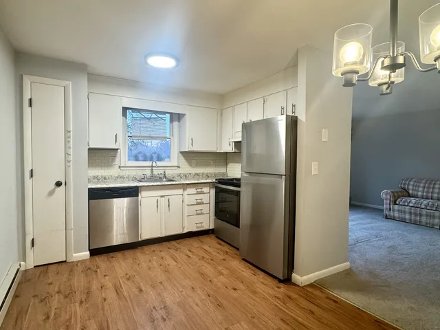 a kitchen with stainless steel appliances granite countertop a refrigerator and a stove top oven