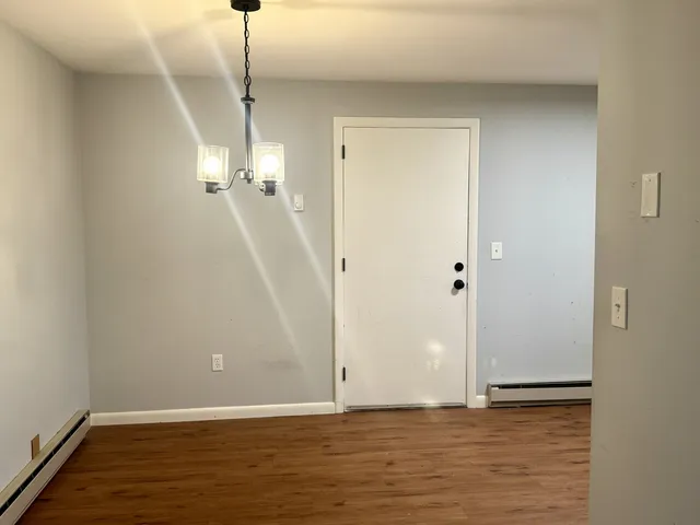 a view of a room with wooden floor and staircase