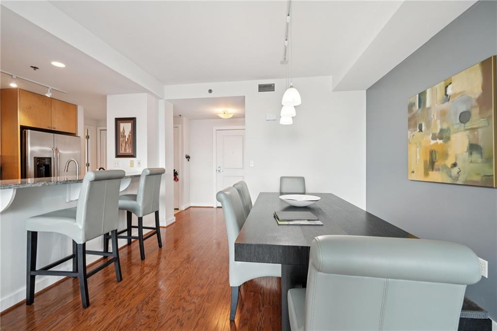 3338 Peachtree Road Northeast, Unit 3006 Atlanta, GA 30326 - Photo 11 of 35 a view of a dining room with furniture and wooden floor