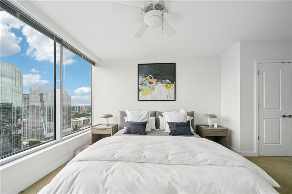 3338 Peachtree Road Northeast, Unit 3006 Atlanta, GA 30326 - Photo 17 of 35 a bedroom with a large bed and a chandelier