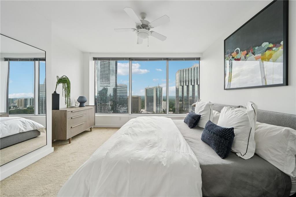 3338 Peachtree Road Northeast, Unit 3006 Atlanta, GA 30326 - Photo 19 of 35 a spacious bedroom with a bed and glass walk in closet