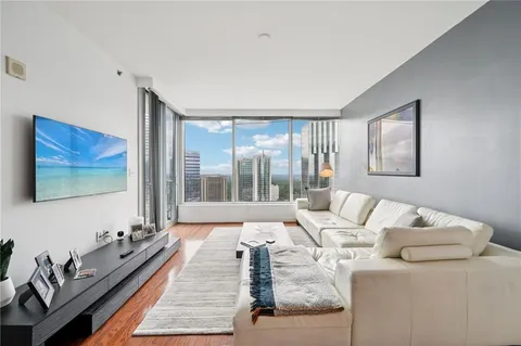 a living room with furniture and a floor to ceiling window