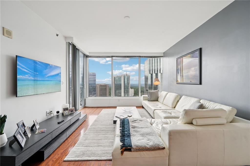 3338 Peachtree Road Northeast, Unit 3006 Atlanta, GA 30326 - Photo 2 of 35 a living room with furniture and a floor to ceiling window