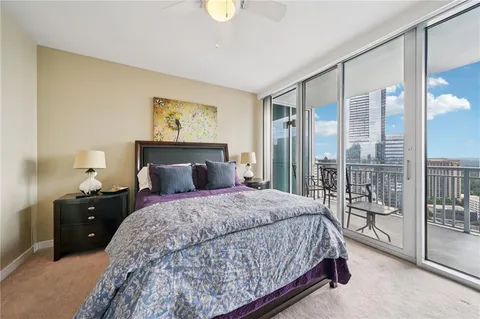 a bedroom with a large bed and a chandelier