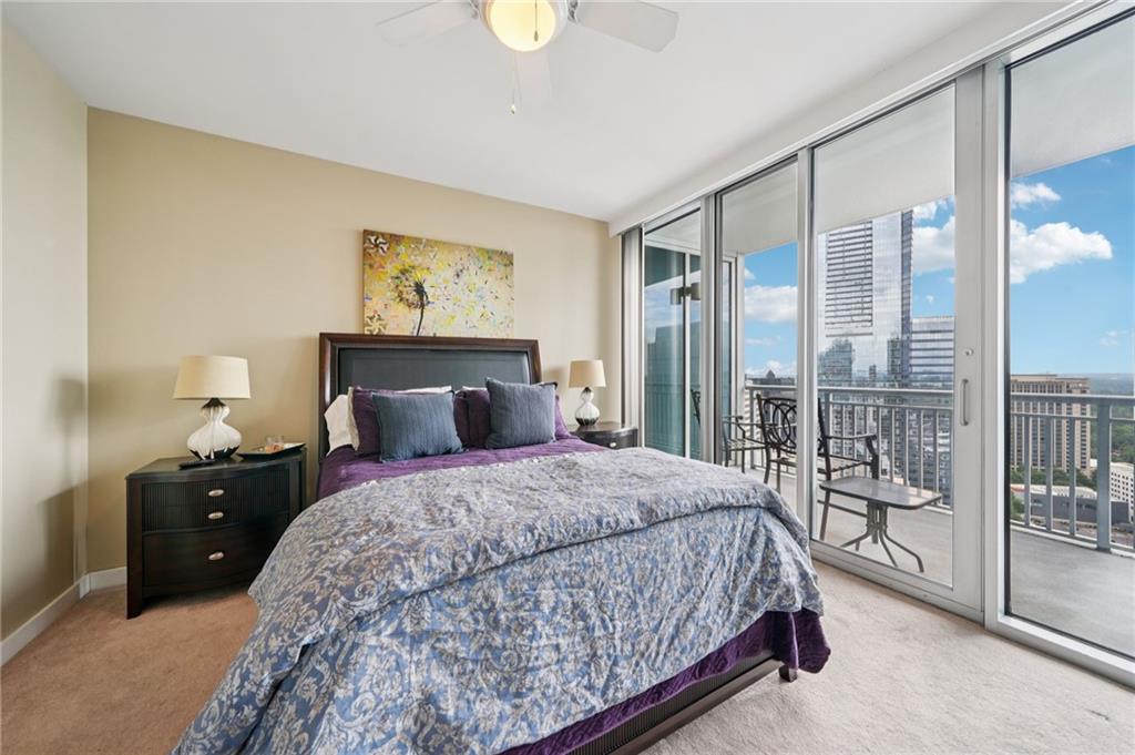 3338 Peachtree Road Northeast, Unit 3006 Atlanta, GA 30326 - Photo 23 of 35 a bedroom with a large bed and a chandelier