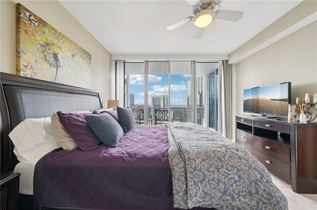 3338 Peachtree Road Northeast, Unit 3006 Atlanta, GA 30326 - Photo 24 of 35 a bedroom with a bed and a flat tv screen on dresser