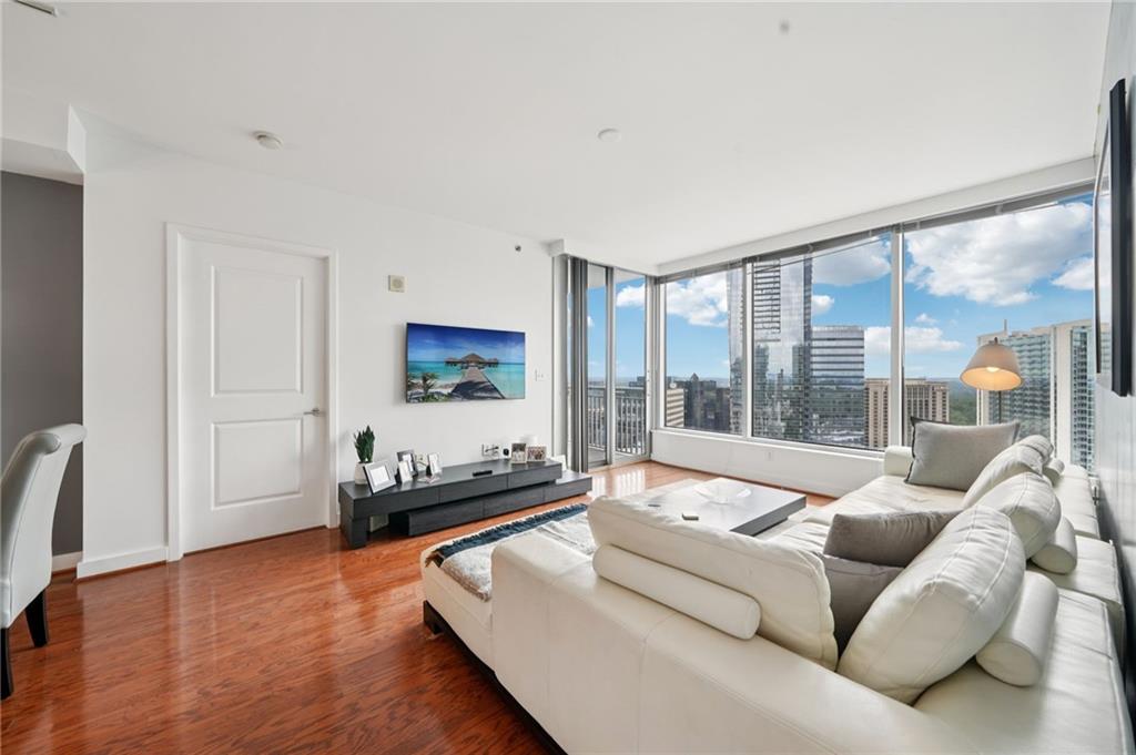 3338 Peachtree Road Northeast, Unit 3006 Atlanta, GA 30326 - Photo 5 of 35 a living room with furniture and a large window