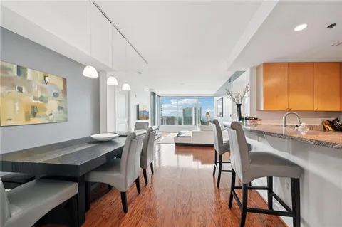 a view of a dining room with furniture and wooden floor