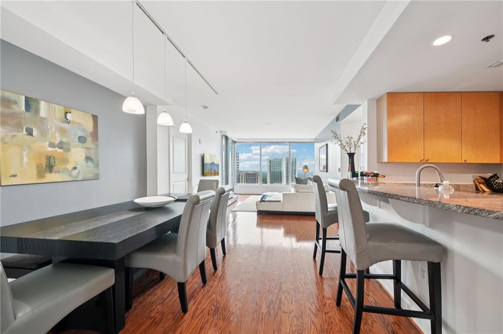 3338 Peachtree Road Northeast, Unit 3006 Atlanta, GA 30326 - Photo 8 of 35 a view of a dining room with furniture and wooden floor
