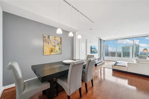 a view of a dining room with furniture wooden floor and a large window