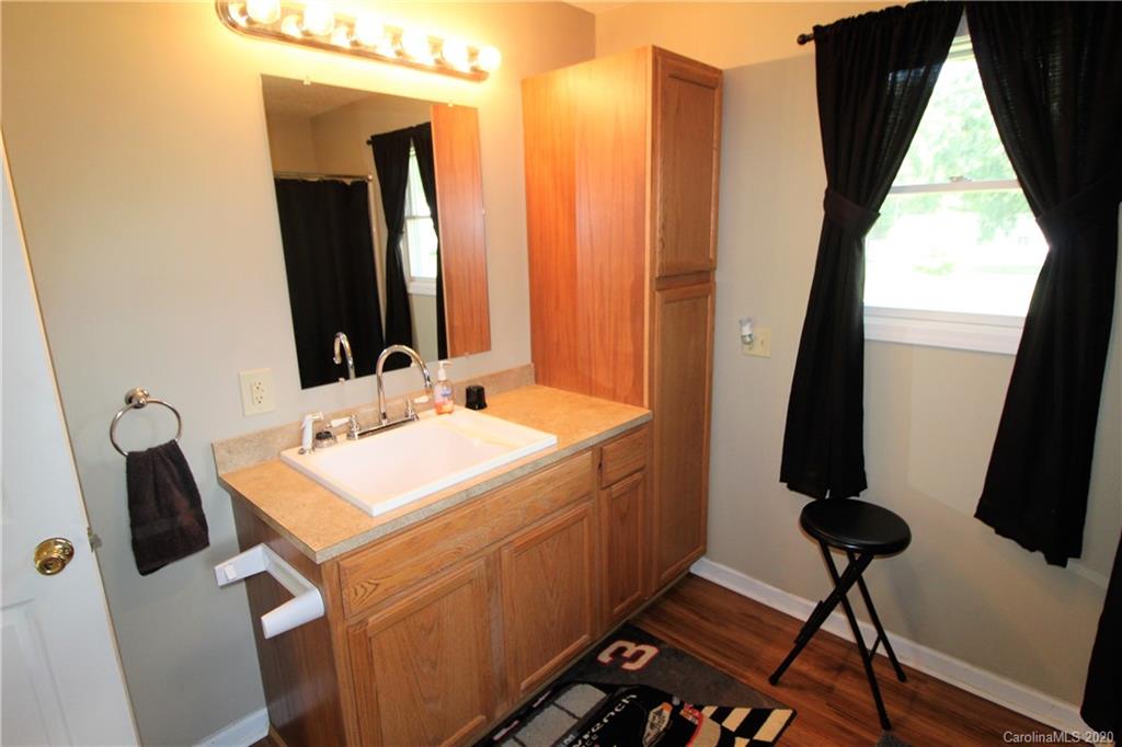2333 Lawrence Road Clover, SC 29710 - Photo 14 of 35 a bathroom with a sink a mirror and a shower