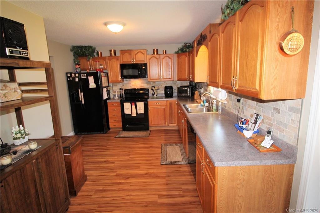 2333 Lawrence Road Clover, SC 29710 - Photo 7 of 35 a kitchen with stainless steel appliances kitchen island granite countertop a refrigerator a stove top oven a sink and dishwasher