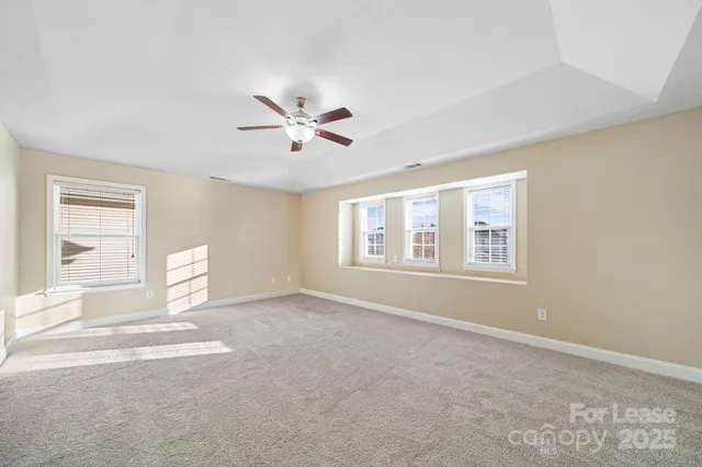 a view of a livingroom with a ceiling fan and window