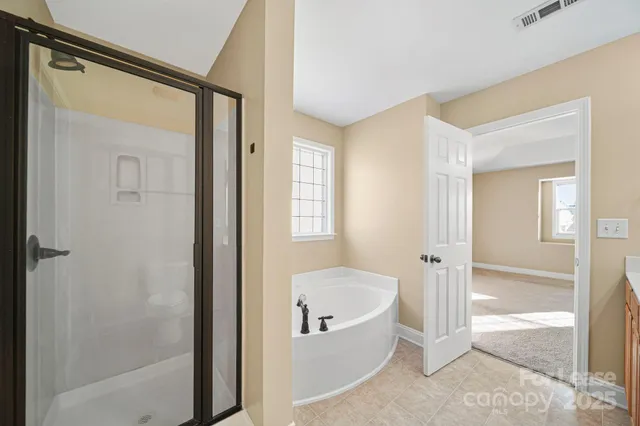 a bathroom with a bathtub and a shower