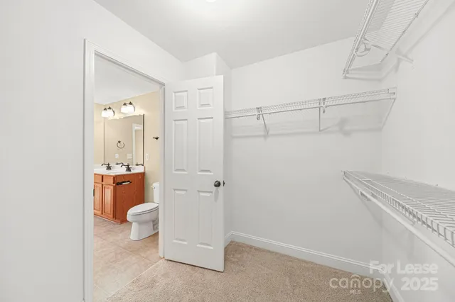 a bathroom with a granite countertop sink and toilet