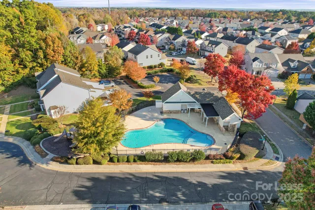 an aerial view of a house with a swimming pool
