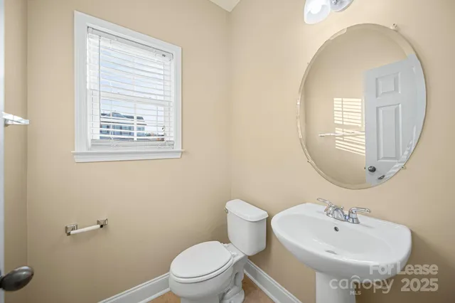 a bathroom with a sink a mirror and a toilet