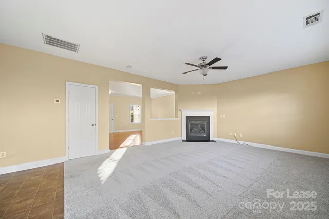 a view of a livingroom with a ceiling fan and a window
