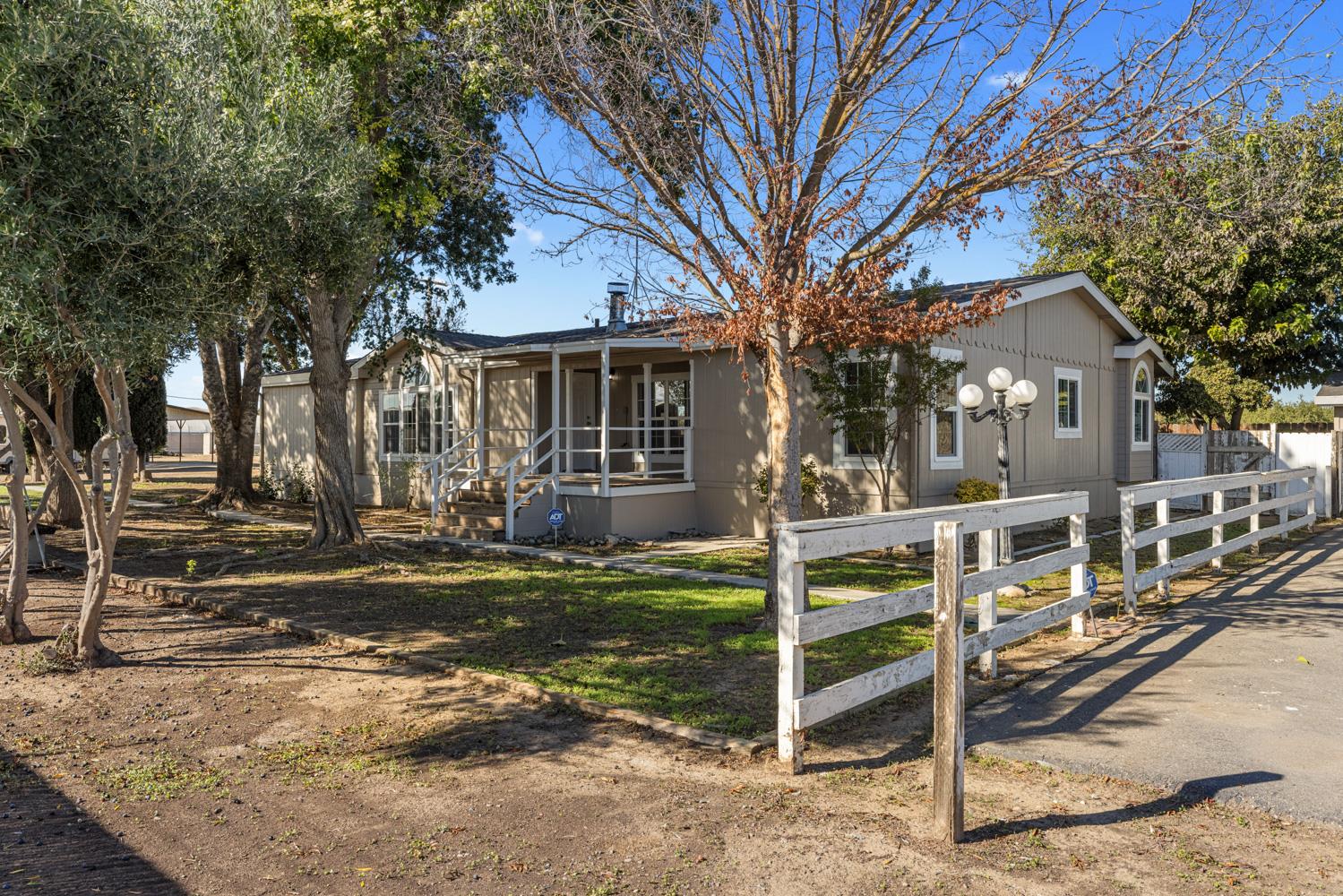a front view of a house with a tree