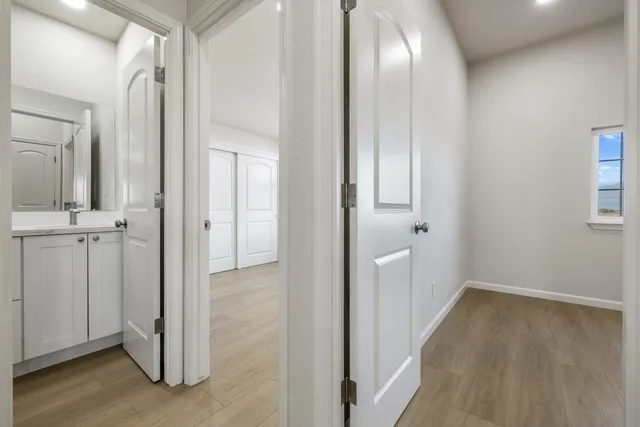 wooden floor in an empty room with a window